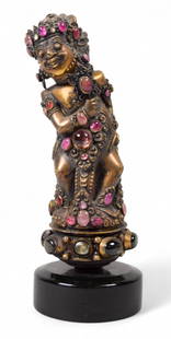 Balinese Gilt Metal & Jeweled Kris Handle: Bali, Indonesia, gilt metal keris / kris handle, inlaid with semi-precious gemstones. 5 1/2"H (with wooden stand 6 1/2"H). Provenance: The estate of Fred Leighton, New York City. Fred Leighton was a j