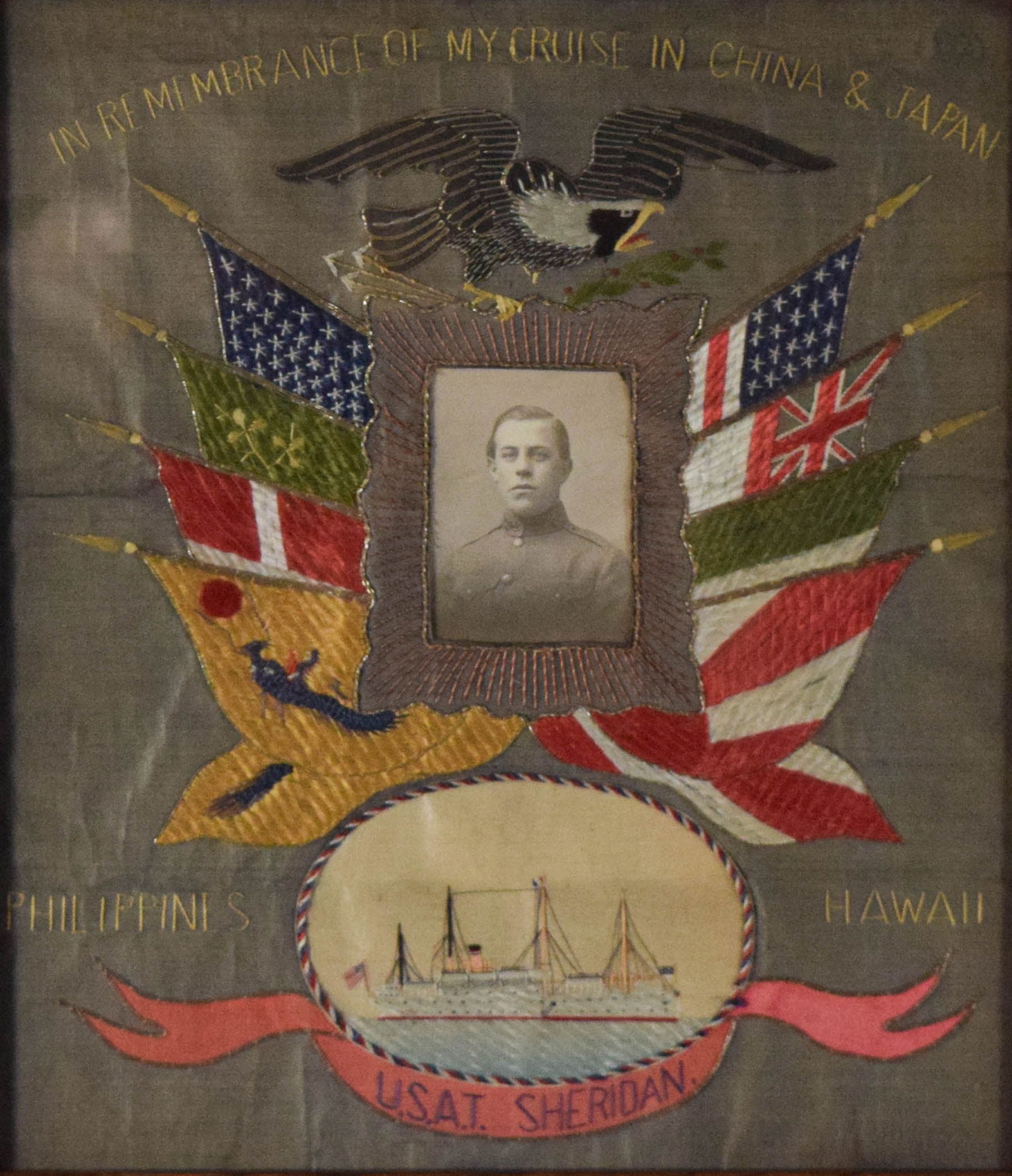 USAT Sheridan Cruise Embroidery: Cruise embroidery U.S.A.T. Sheridan, "In remembrance of my cruise in China & Japan / Philippines / Hawaii / U.S.A.T. Sheridan". With photograph at center. C. late 19th-early 20th century. 15 1/2" x 13