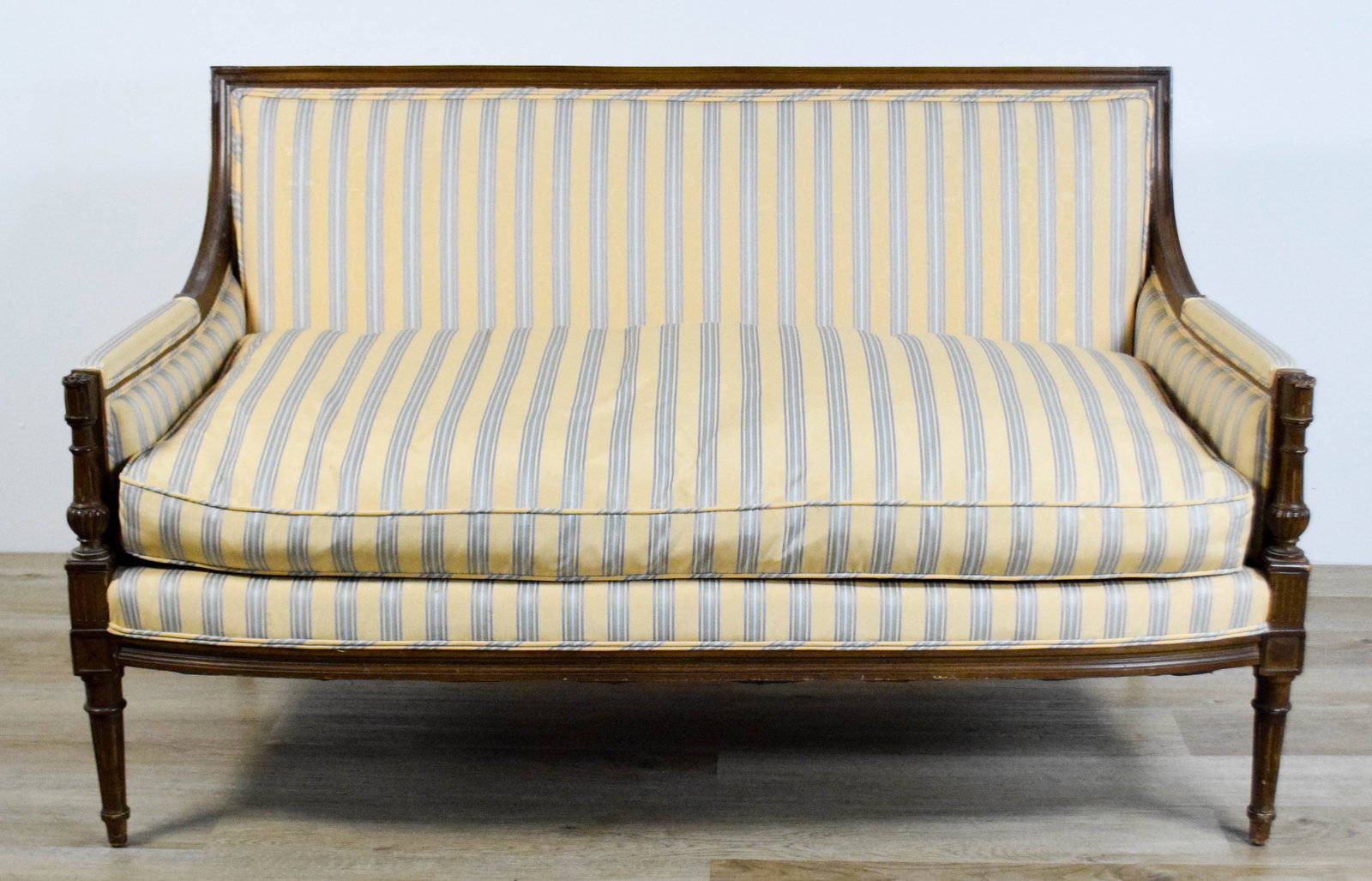 Louis XVI Style Settee: Louis XVI style settee sofa. Unsigned. 55 3/4"L x 32 1/4"D x 33 1/4"H. Chips and losses to wood on legs, arms and throughout; stains and discoloration to upholstery.