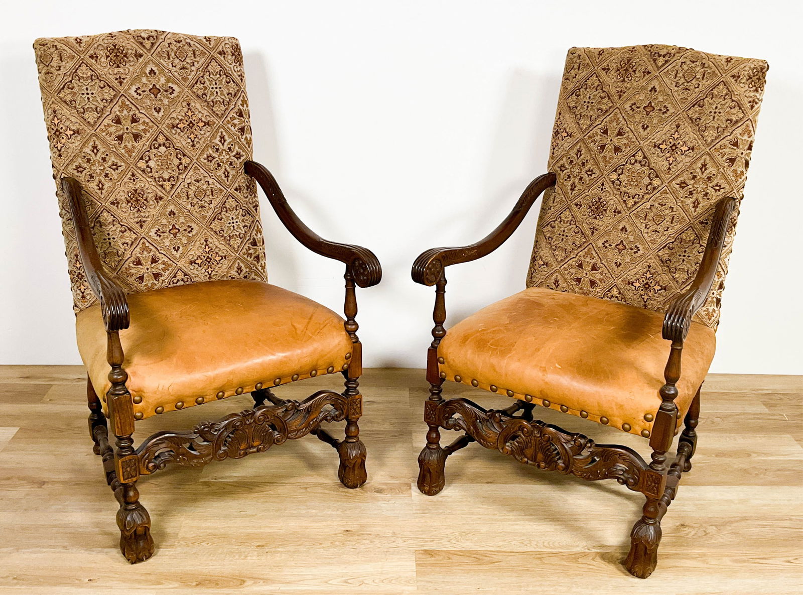 Pair Louis XIV Style Armchairs: Pair of Louis XVI style library armchairs. Carved lion paw feet. Nail heads. Rubbing, nicks and losses throughout. Seats and backs with staining and marks. 47" Tall x 26 1/2" Wide x 24" Deep x 19 1/2"