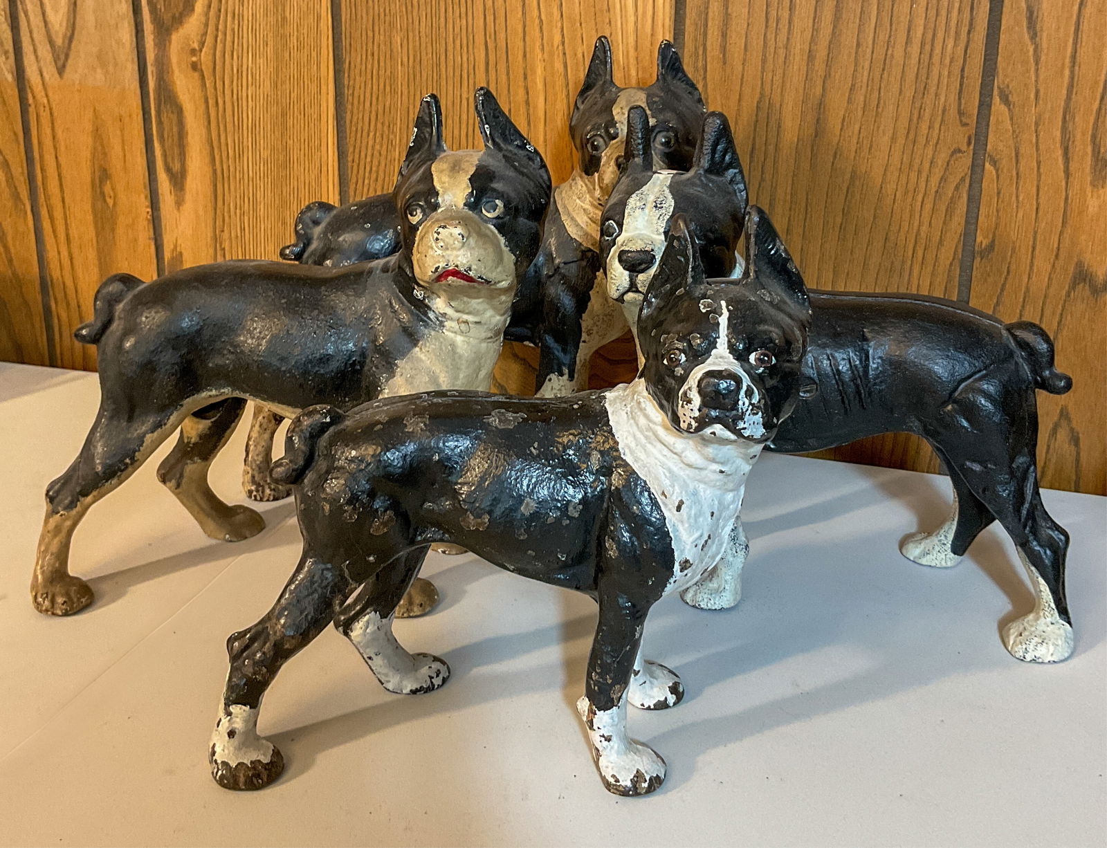4 Cast Iron Boston Terrier Doorstops: Four vintage cast iron black and white Boston Terrier door stops. Wear throughout, including chipped paint. Largest 10" w x 10.5" h x 4.5 " deep.