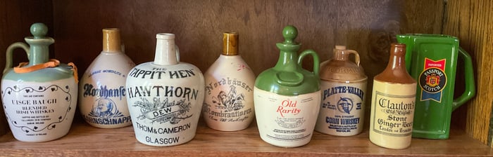 8 Vintage Stoneware Whiskey Bottles
