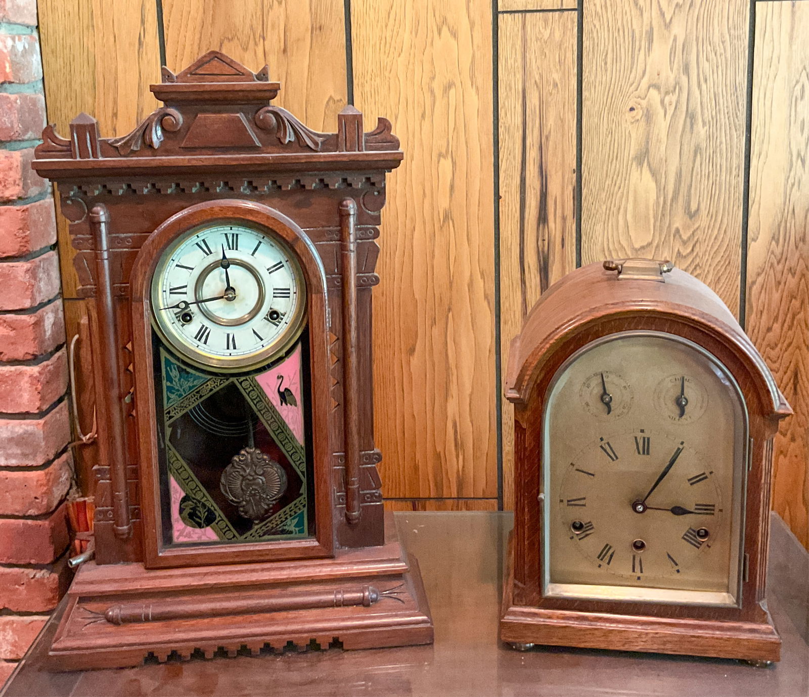Two Wooden Mantel Clocks: Wood mantel clock decorated with pink and black floral and bird imagery. Brass pendulum visible through glass panel. Not tested. Some damage to top on reverse. Mantel clock in a wooden case with arche
