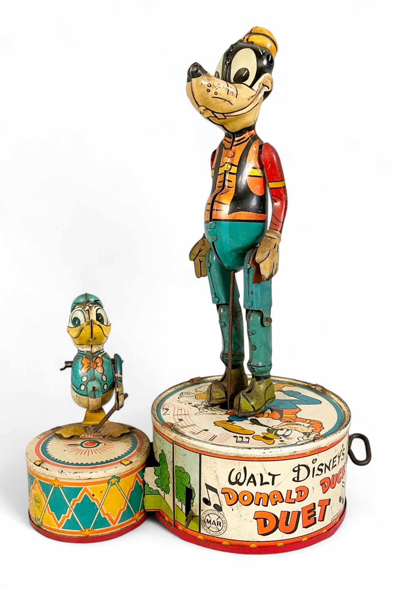 Marx Walt Disney's Donald Duck Duet Tin Litho Toy: Vintage Marx tin litho wind-up toy, Walt Disney's Donald Duck Duet. Marked Marx Toy and Copyright 1946 Walt Disney Productions. 10 1/4"H. Partially works. Rusting and paint loss throughout, Donald Duc