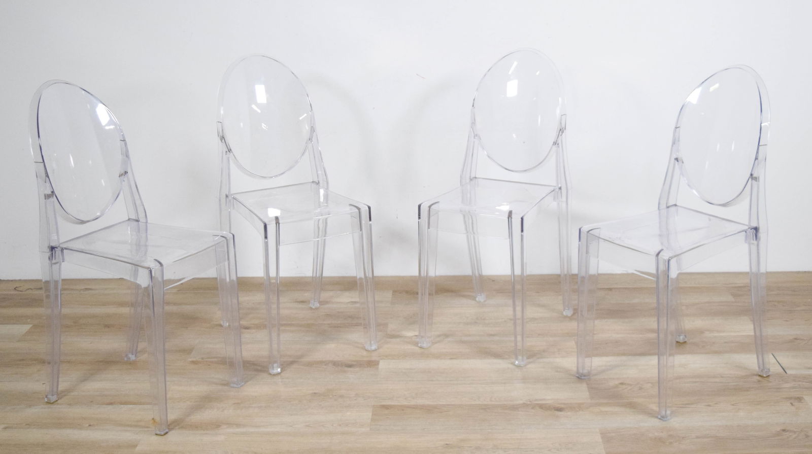 4 Philipe Stark Style Ghost Chairs: 4 Ghost chairs in the style of Philipe Stark for Kartell. Lucite chairs Scratches throughout. Some cracks at feet. Missing some rubber from feet. 35" T x 14" W x 15 1/2" D. Seat Height 18 1/2".