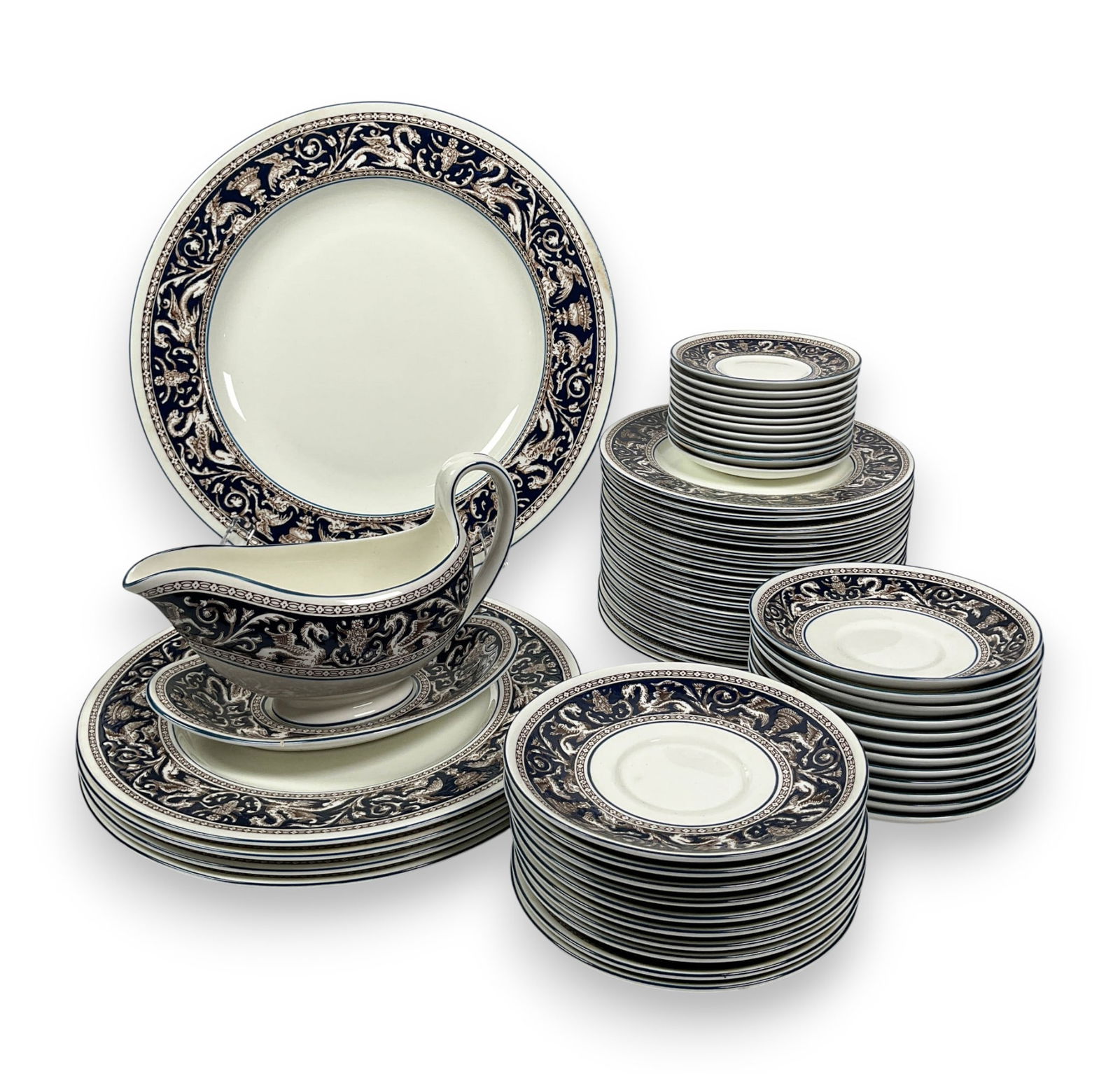 57 Wedgwood Florentine Plates & Gravy Boat: 57 Wedgwood Florentine plates and one gravy boat. Marked Wedgwood Florentine 1956 on underside. Dinner plate 13 1/4" diameter. Hairline cracks along some plates and slight surface grime present throug