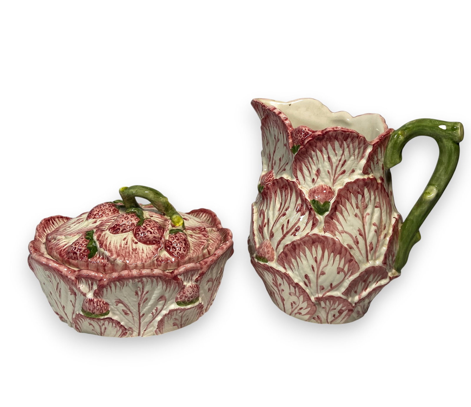 Portuguese Majolica Strawberry Pitcher and Tureen: Two pieces of Portuguese majolica in strawberry pattern including one pitcher and one tureen. Marked on the underside of each Made in Portugal for Neuwirth. Pitcher 7 1/4" H x 7 1/2" W x 3 1/2" diamet