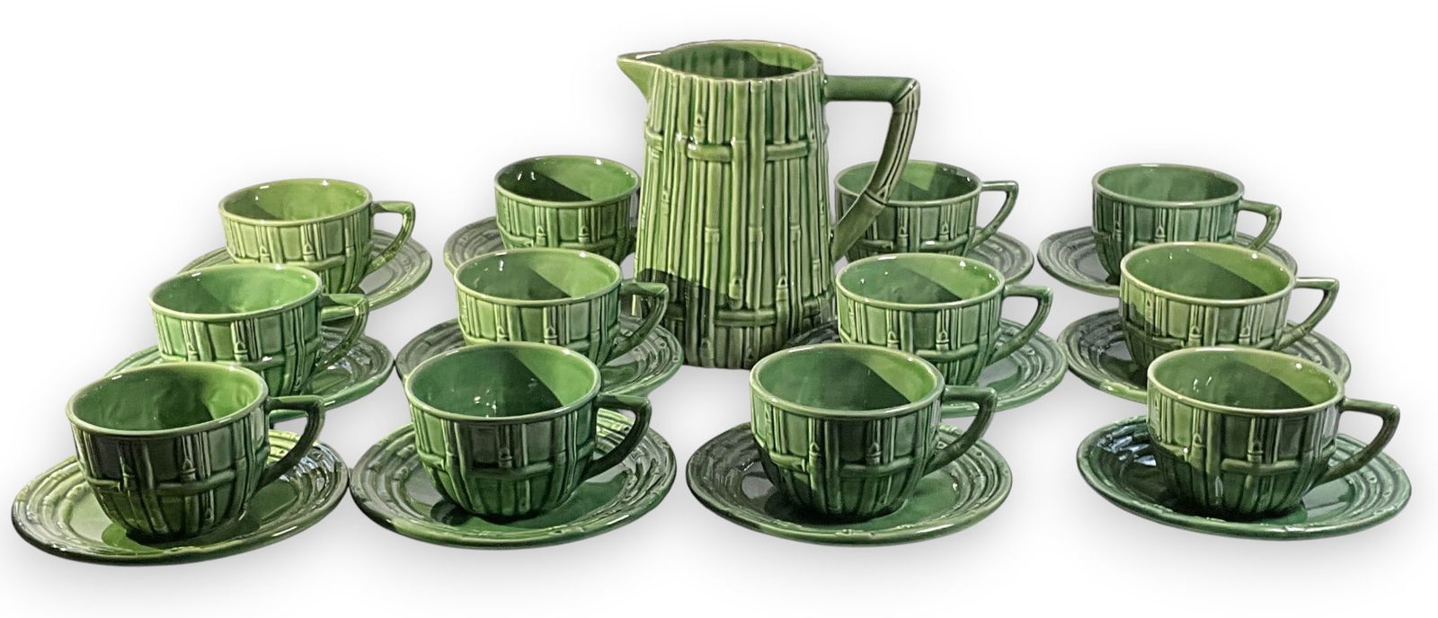 25 Pcs Bordallo Pinheiro Majolica Bamboo Tea Cups: 25 pieces of Bordallo Pinheiro majolica in Bamboo pattern including twelve tea cups and saucers and one pitcher. Marked Bordallo Pinheiro Made in Portugal on underside of each. Pitcher 7" H x 4 1/4" W