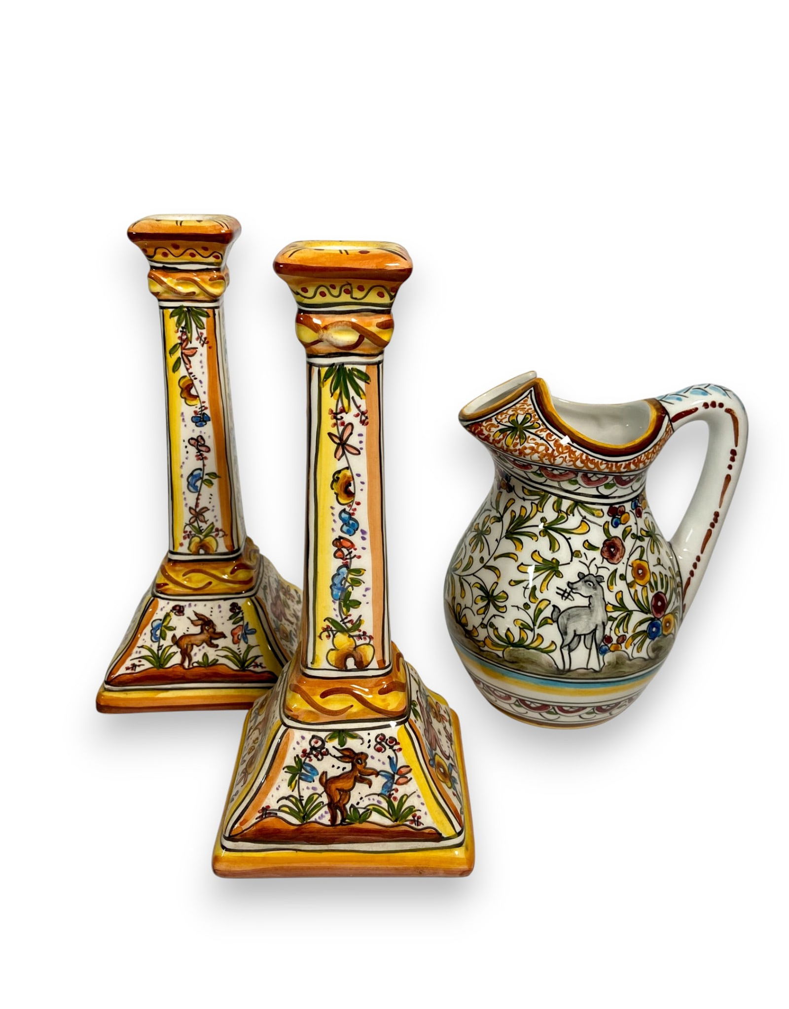Portuguese Majolica Holu Candlesticks & Pitcher: Three pieces of Portuguese majolica including a pair of candlesticks and a pitcher. All marked on the underside. Candlesticks 9 1/2" H x 4" diameter. No visible damage.