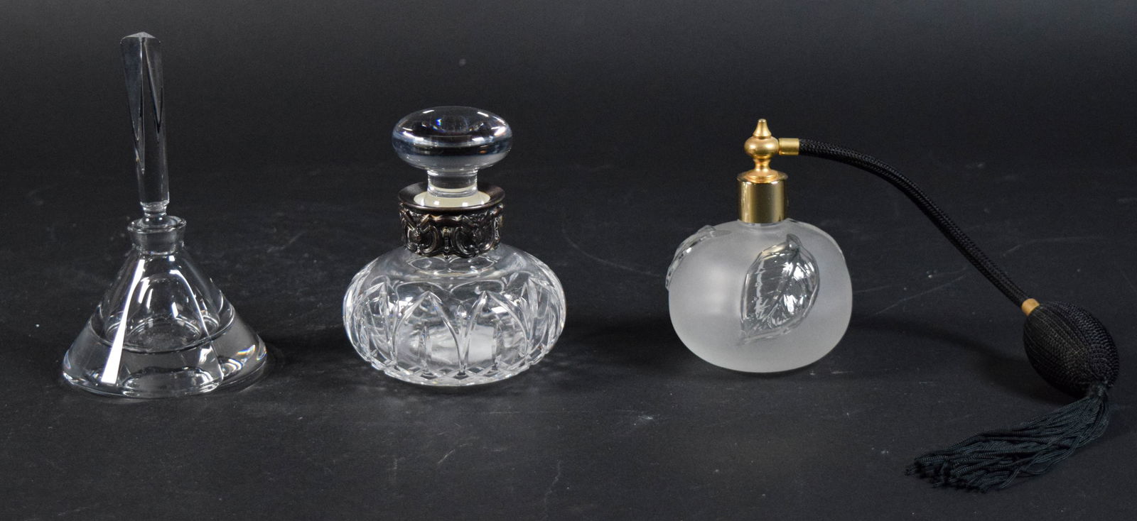 3 Crystal Perfumes: Group of 3 crystal perfumes. Lalique style frosted glass atomizer, unsigned, 4"H; Baccarat style bottle with stopper, unsigned, 5 1/2"H to top of stopper; Atlantis bottle with stopper and silverplate