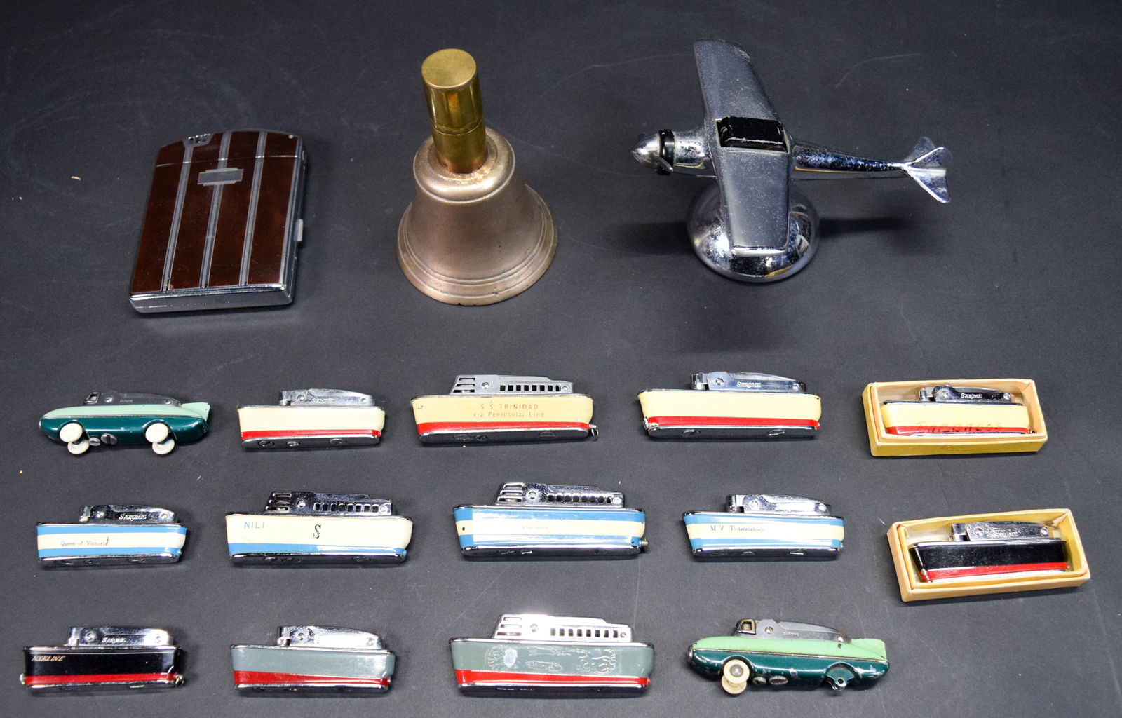 17 Vintage Lighters Ronson, Sarome: 17 vintage lighters. Ronson lighter / cigarette case, 2 Sarome Blue Bird car lighters, 12 Sarome Cruiser ship lighters including 2 in original boxes, brass bell form lighter, airplane table lighter. A