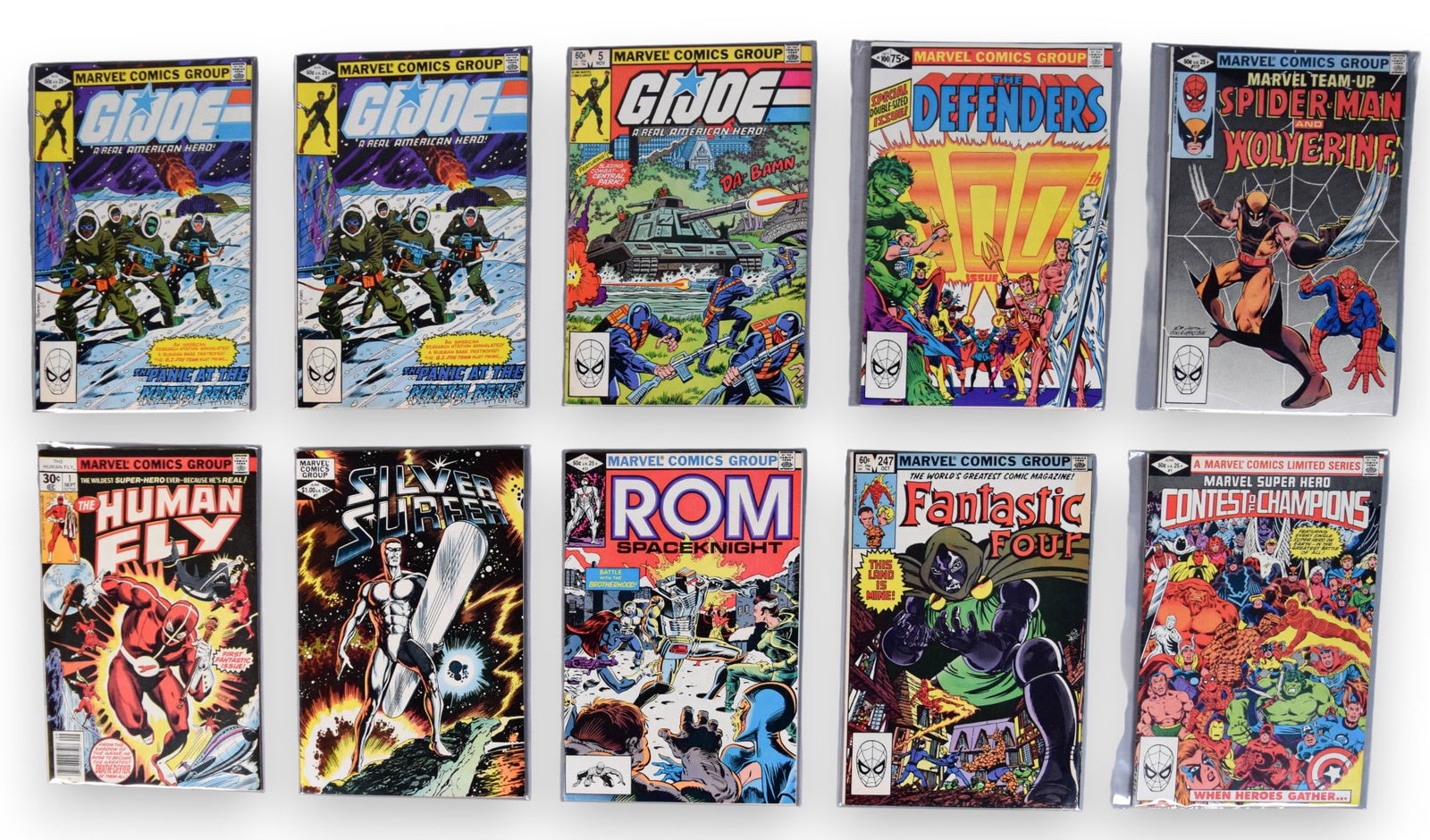 10 Marvel Comics Wolverine Spiderman: 10 Marvel comics, including Defenders 100, Marvel Team Up 117 Spiderman and Wolverine, Contest of Champions 1, Fantastic Four 247, (2) G.I. Joe 2, G.I. Joe 5 Rom 31, Silver Surfer 1, the Human Fly 1.