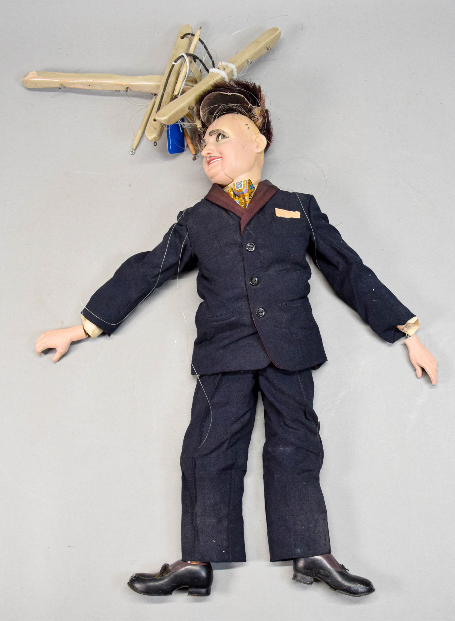 Bob Baker Marionette George Liberace: Bob Baker, marionette of George Liberace. Composition, wood, fabric and other materials. 23 1/4"L. Strings tangled, hair detached, chip to one shoe, paint loss to shoes and face. Provenance: The Bob B