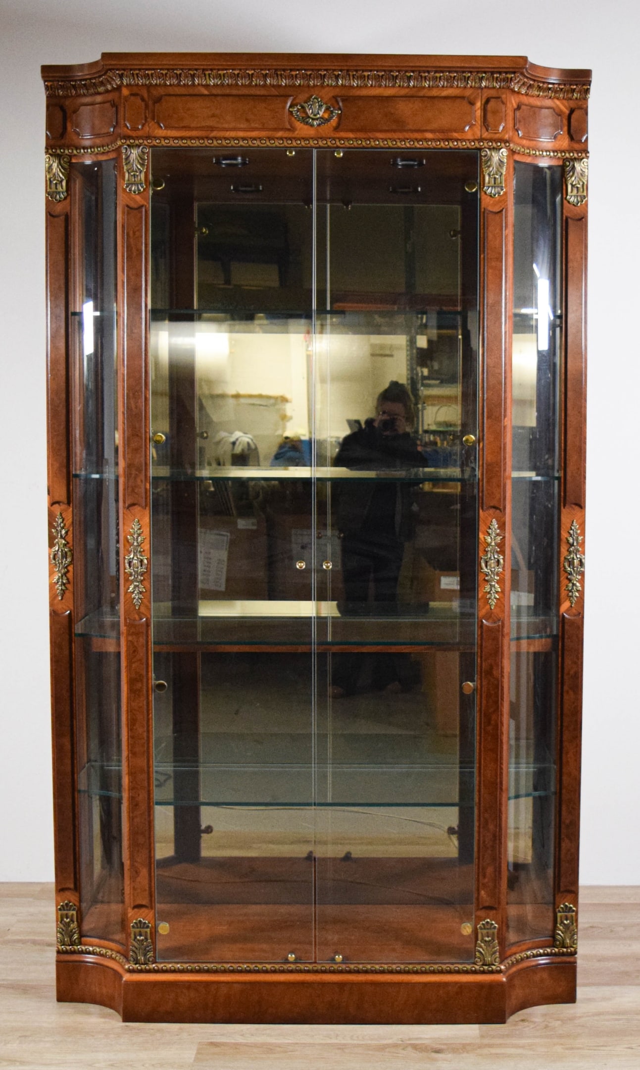 Henredon Grand Provenance Display Cabinet: Henredon "Grand Provenance" lighted display cabinet. 2 glass doors, 4 interior glass shelves. Paper Henredon labels on the rear panel. 84"H x 48"W x 17"D. Lighting working. Minor chip to the base.