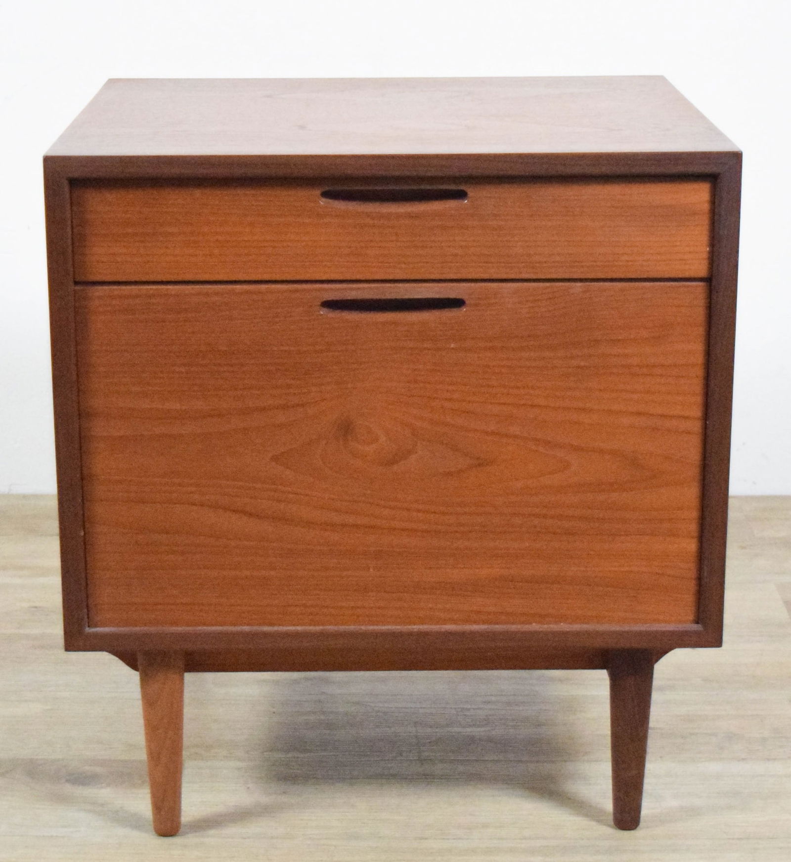 Danish Modern Nightstand / Side Table: Danish modern nightstand or side table. One drawer over drop front cabinet. Danish control tag to interior of drawer. 23 3/4"H x 21 5/8"W x 17 3/4"D. Top with stains and scratches, minor wear