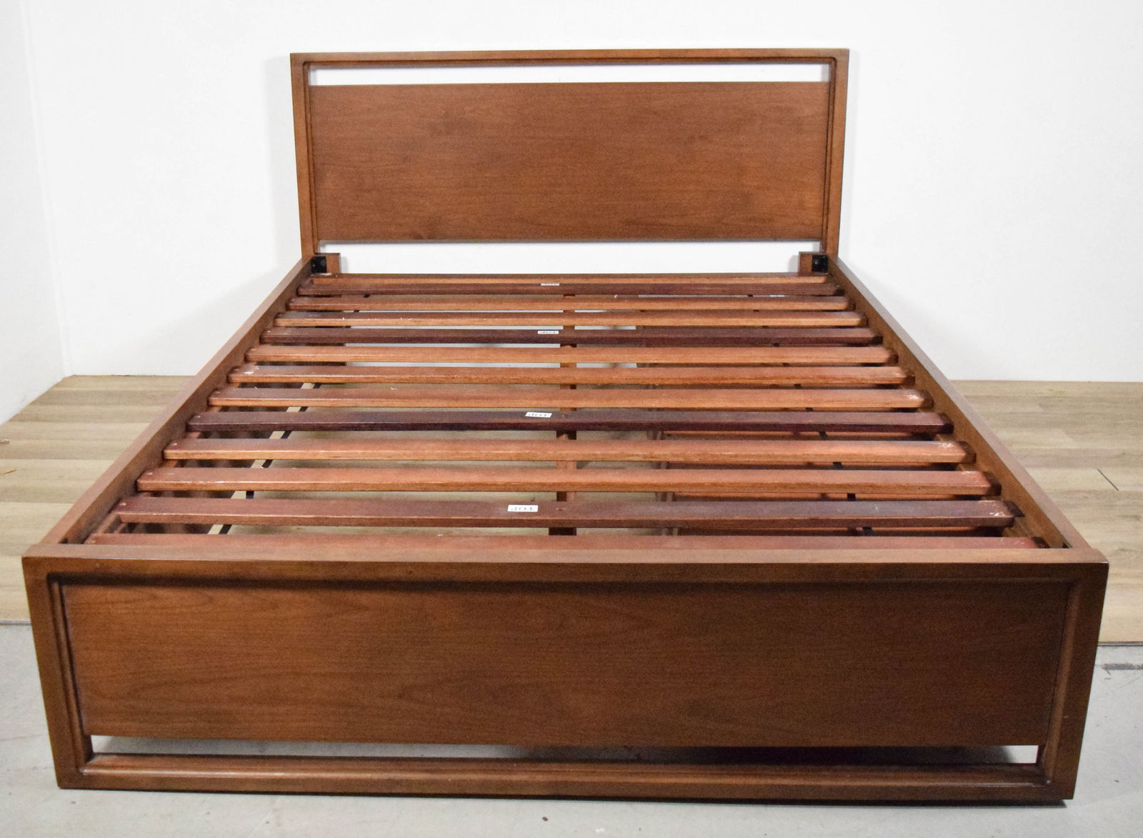 Danish Modern Queen Style Bed With Drawers: Danish modern style Queen bed, with 3 drawers on one side. 40 1/4"H x 64"W x 85 3/4"L. Scratches to frame along one side, minor wear throughout, chips and scratches to slats.