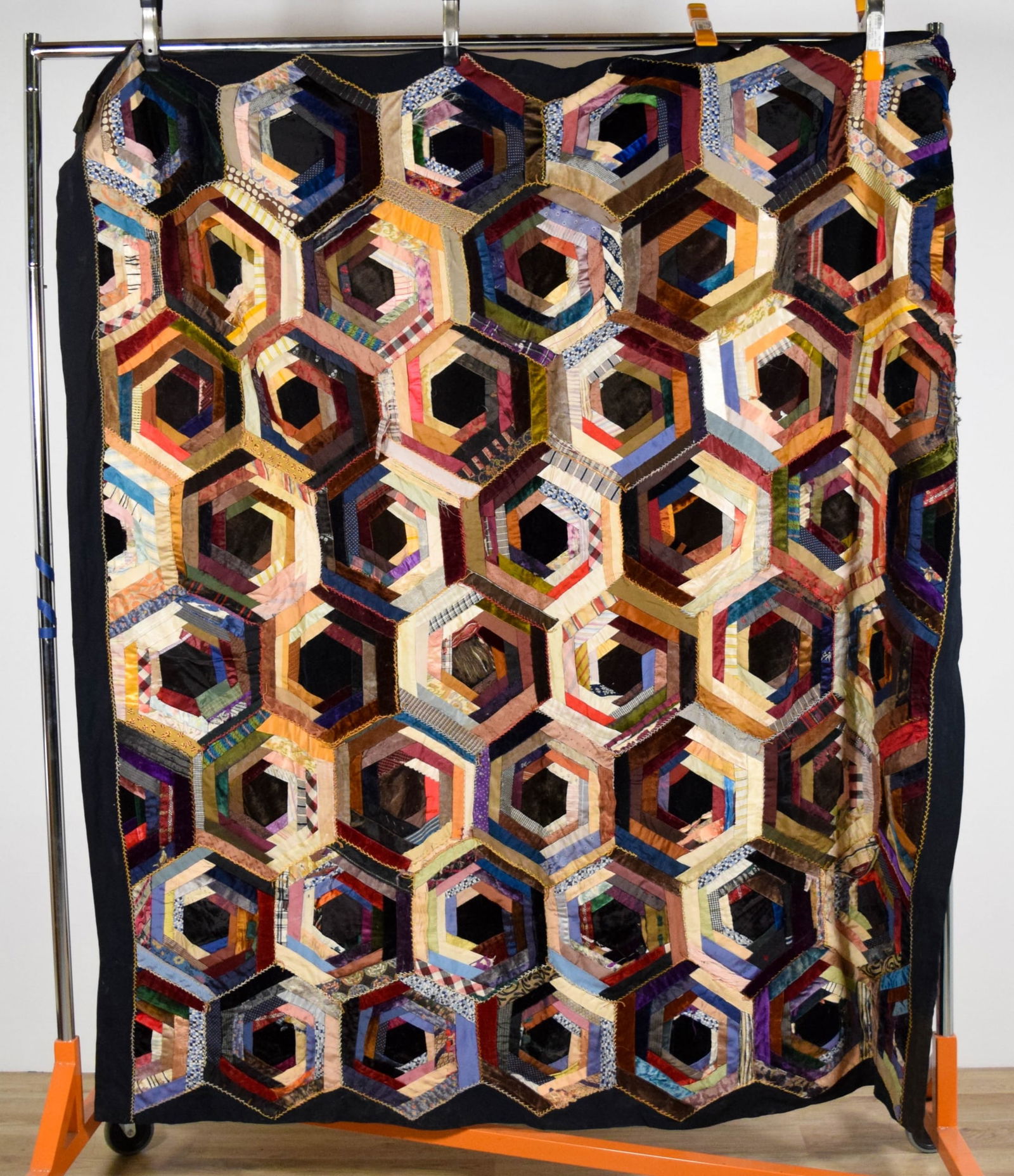 Crazy Quilt Hexagon Pattern: Hand stitched crazy quilt, hexagon pattern, 73" x 64 1/2". With an additional crazy quilt section, 60 1/2"x 25". Quilt with tears and fraying throughout.