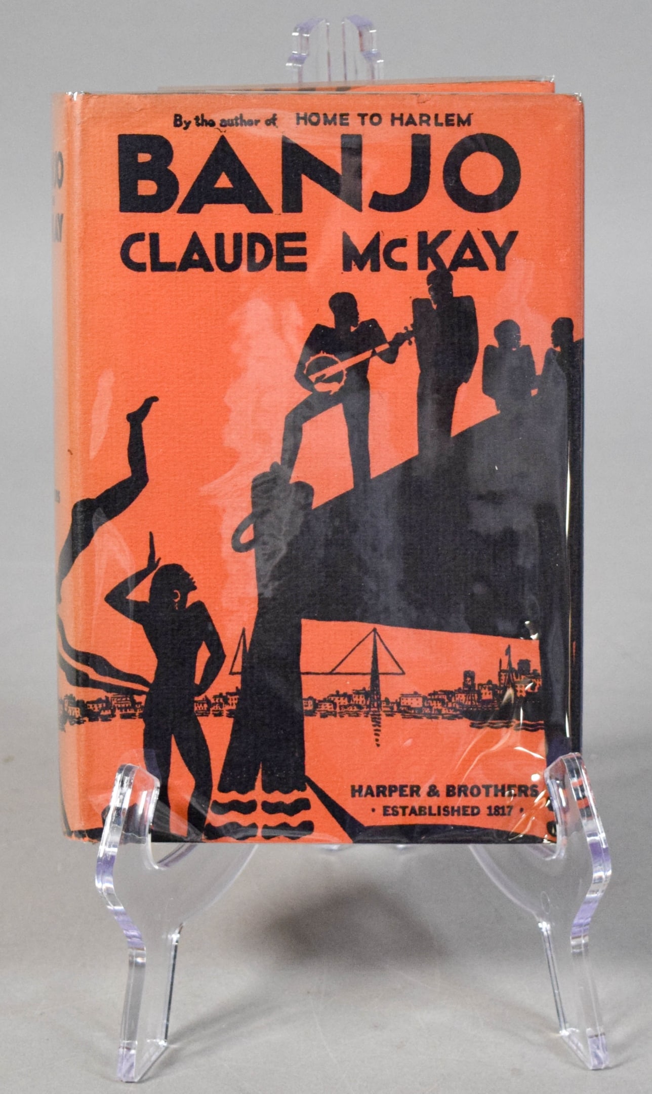 Claude McKay Banjo First Edition 1929: Claude McKay (Jamaican / American, 1890-1948). Banjo: A Story Without a Plot, Harper & Brothers, 1929. First edition, with dust jacket. 7 3/4" x 5 1/2". Toning to pages, binding loose, minor tears and