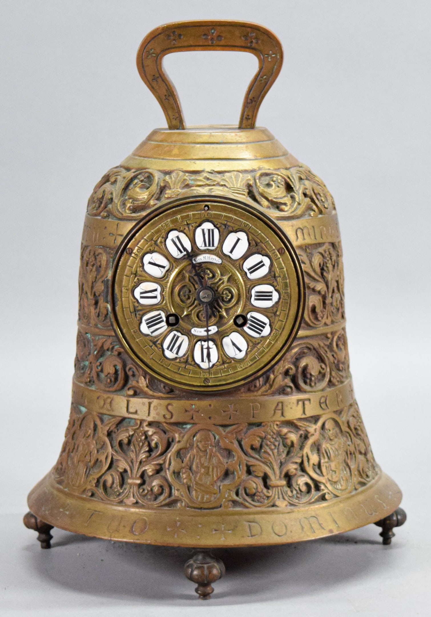 Alex Hays Bronze Bell Clock: Alex Hays bell form mantel clock. Bronze, enamel numerals, marked Alex Hays New York on the dial. 12 1/2"H x 9 1/8"-diameter at base. Minor losses to enamel on numerals, roughness along base, no glass