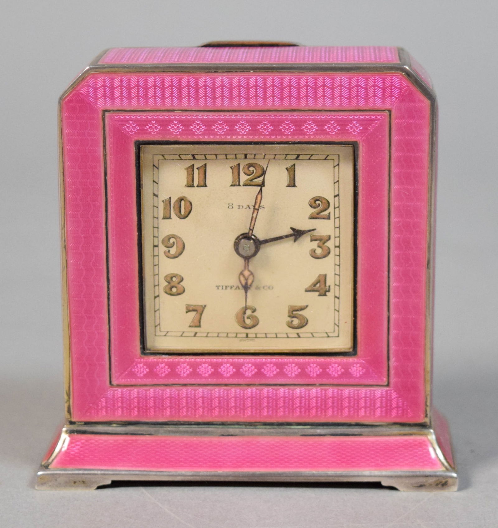 Tiffany & Co. Guilloche Enamel & Silver Clock: Art deco Tiffany & Co. pink guilloche enamel and silver 8 day travel / desk clock. Dial marked Tiffany & Co., clock marked Continental Lemania Inc Swiss on the reverse, and with illegible hallmark on