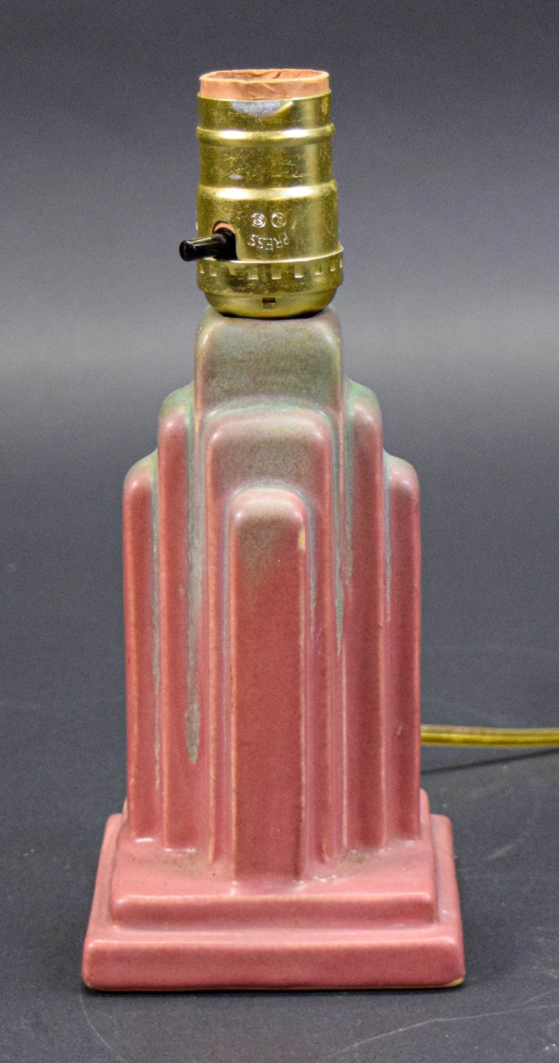 Reuben Haley for Muncie Pottery Skyscraper Lamp: Reuben Haley for Muncie Pottery, art deco Skyscraper lamp. Impressed DLS and 4 on the underside. 8 3/8"H to top of socket. In working condition. Some crazing, flake on one edge.