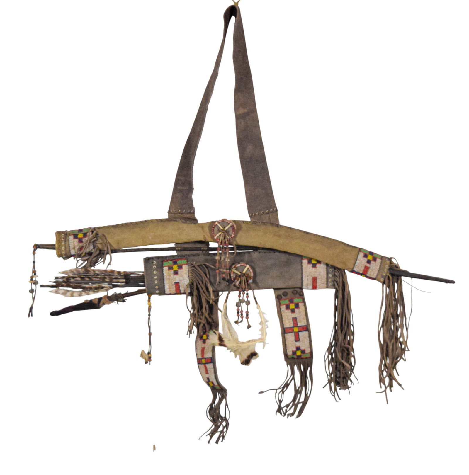 Native American Bow and Arrow in Suede Quiver: Native American bow and arrow set, attributed to North American Plains. Wooden bow with suede grip. 4 wooden arrows with stained shafts and tipped with metal points. Housed in suede bow case with atta