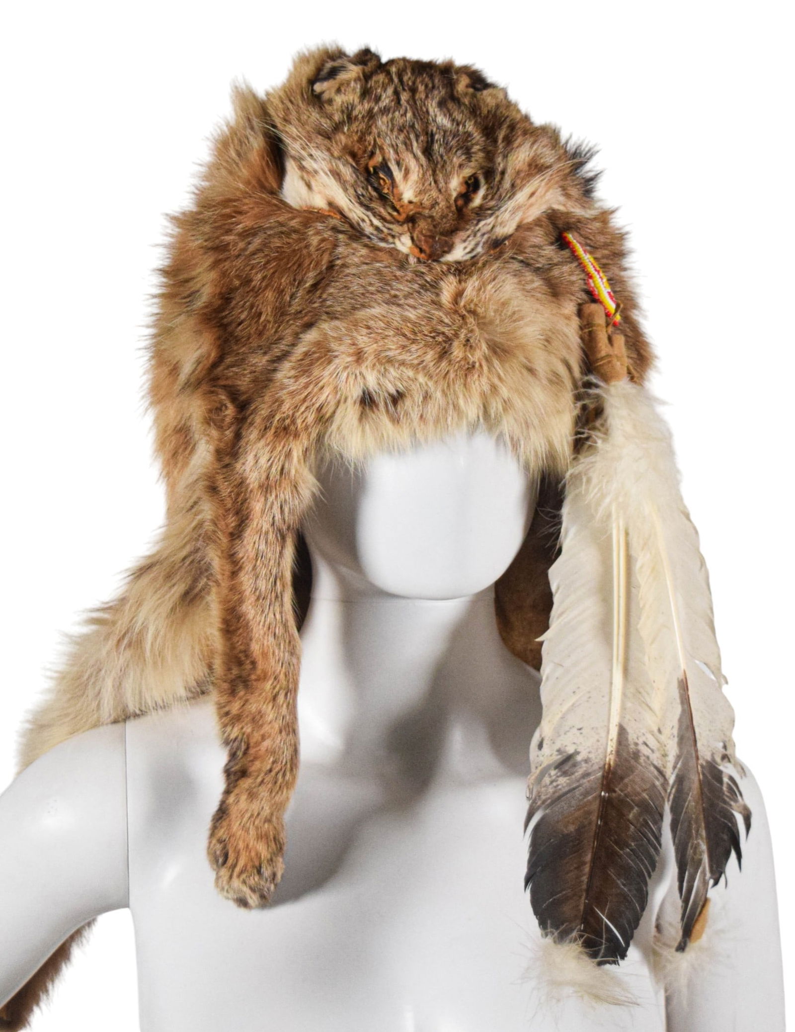 Contemporary Lynx Pelt Headdress: Contemporary lynx pelt headdress crafted in the style of indigenous North American ceremonial regalia. Retains full head, tail, and front paws with claws intact. Interior lined with multi-colored stri