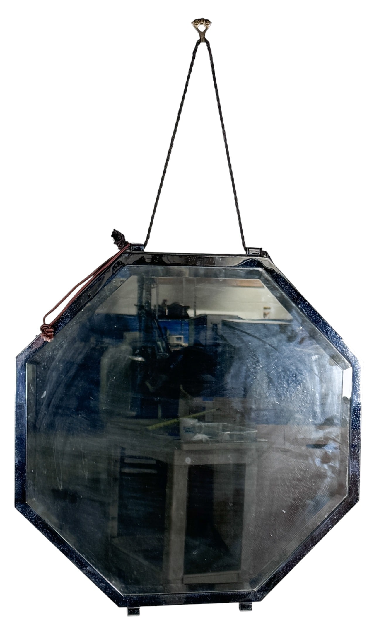 Mid-Century Modern Octagonal Beveled Mirror: This octagonal wall mirror features a mid-century modern aesthetic, constructed with a beveled glass surface secured within a chrome-plated metal frame. The piece is designed to be suspended from a de