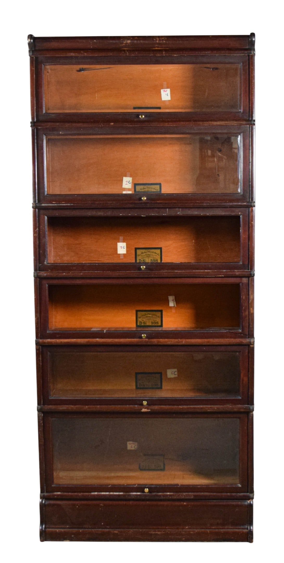 Globe-Wernicke 6 Stack Barrister Bookcase 598: Globe-Wernicke 6 stack barrister bookcase. 6 Bookcase sections, base and top. 598 grade, mahogany finish. As photographed: cap, D 8 1/2, D 10 1/2, D 8 1/2, D 8 1/2, D 8 1/2, D 12 1/4, base. Bookcase s