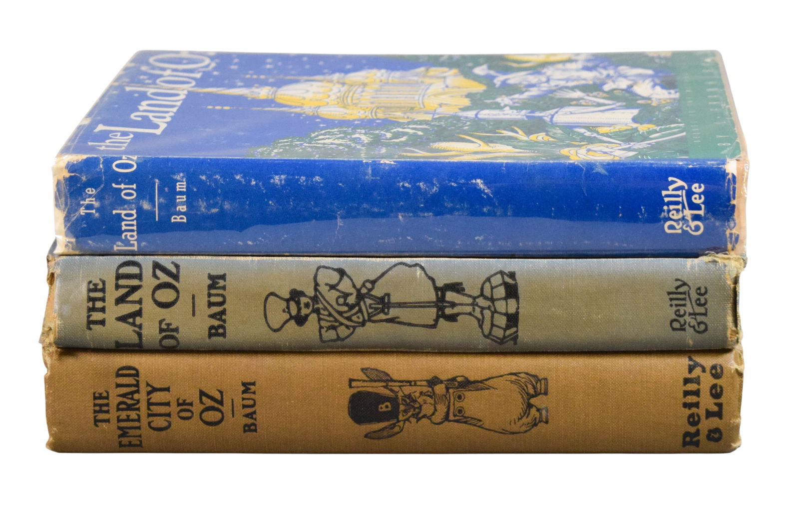 3 L. Frank Baum Oz Books: L. Frank Baum (American, 1856-1919). 3 Oz books. The Land of Oz, Reilly & Lee, 1932, with dust jacket; The Emerald City of Oz, Reilly & Lee, 1910; The Land of Oz, Reilly & Lee, 1939. Emerald City 9 1/