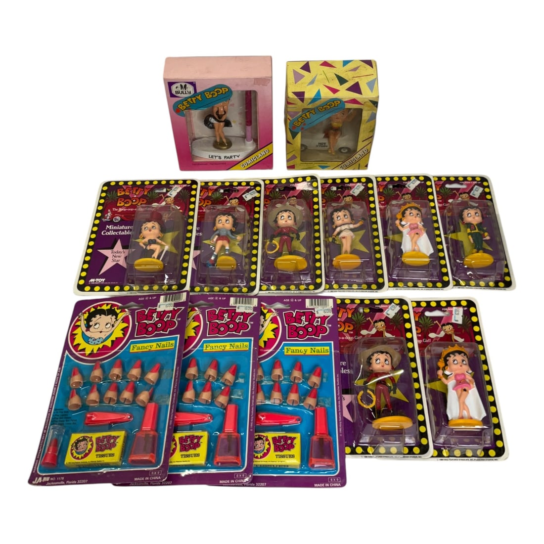 Group of Vintage Betty Boop Collectible Figurines and Memorabilia: Group of 13 vintage Betty Boop collectibles produced between 1986 and 1990. Includes 8 Miniature Collectables plastic figurines by Marty Toy, 2 hand-painted figurines from the Comicland series by Bull