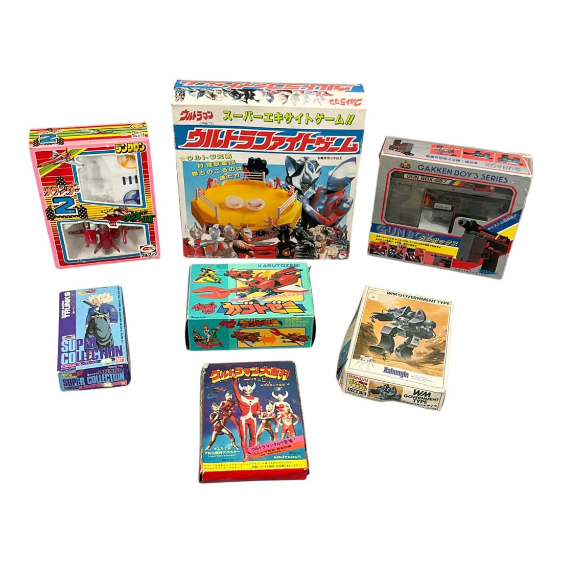 7 - Bandai, Takatoku, and Gakken Vintage Japanese Toy and Model Collection, c. 1983-1992: This curated collection features seven notable Japanese toys and collectibles representing the peak of the late Showa and early Heisei eras. The assortment includes a Bandai 1/144 scale Xabungle Walke