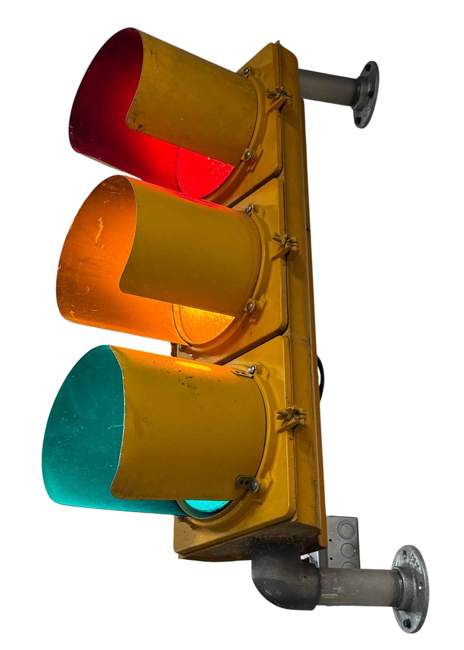 A General Decorative Three-Section Traffic Signal: A General three-section vertical traffic signal featuring a yellow-painted housing with red, amber, and green lenses. Each section is equipped with a matching yellow cowl or visor. The unit is