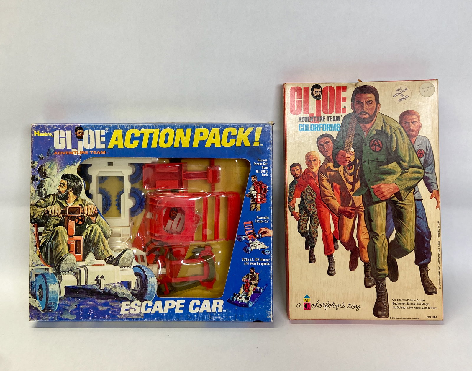 2 Vintage Hasbro G.I. Joe Adventure Team Sets c. 1973: Two vintage 1970s G.I. Joe Adventure Team toy sets including a Hasbro Action Pack! Escape Car and a G.I. Joe Adventure Team Colorforms set with a cardboard background play board, multiple sheets of di