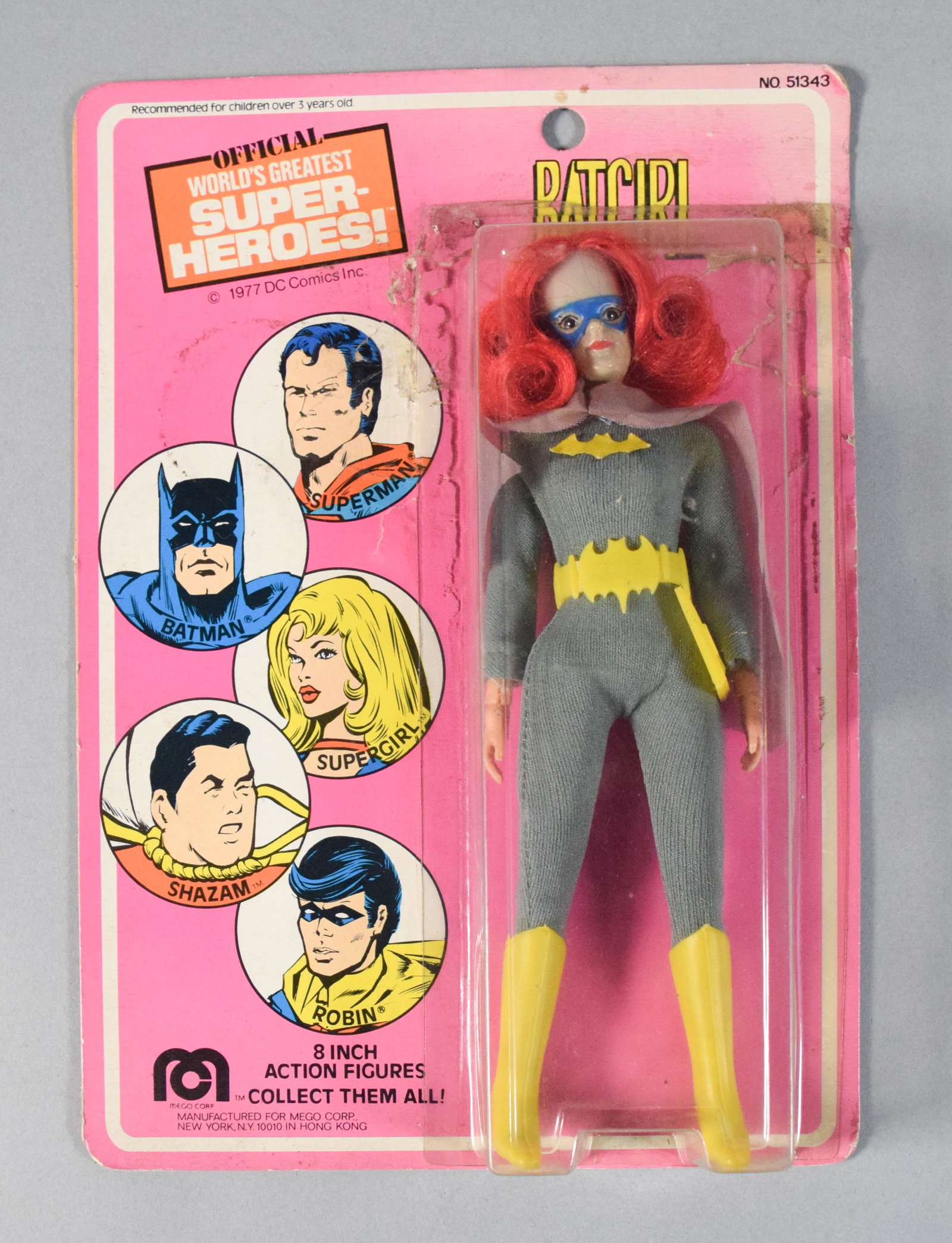Mego 1977 Batgirl 8-Inch Action Figure in Original Packaging: Vintage 8-inch Batgirl action figure from the World's Greatest Super-Heroes line by Mego Corp. The figure is housed in its original carded blister pack marked DC Comics 1977. 10" H x 7" W x 1.5" D.