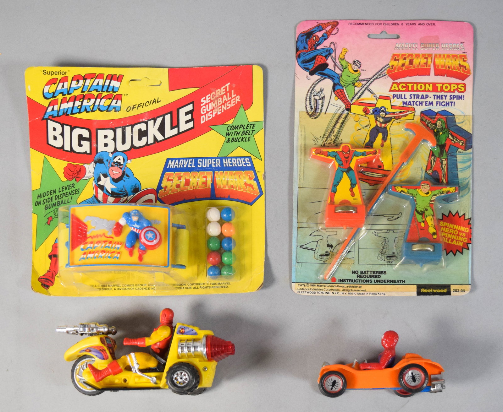 4 Vintage Marvel Super Heroes Secret Wars Toys and Vehicles: Collection of four Marvel Super Heroes themed toy items c. 1980s. The group includes two items in original carded packaging and two loose vehicle sets. The first carded piece is a Captain America Big