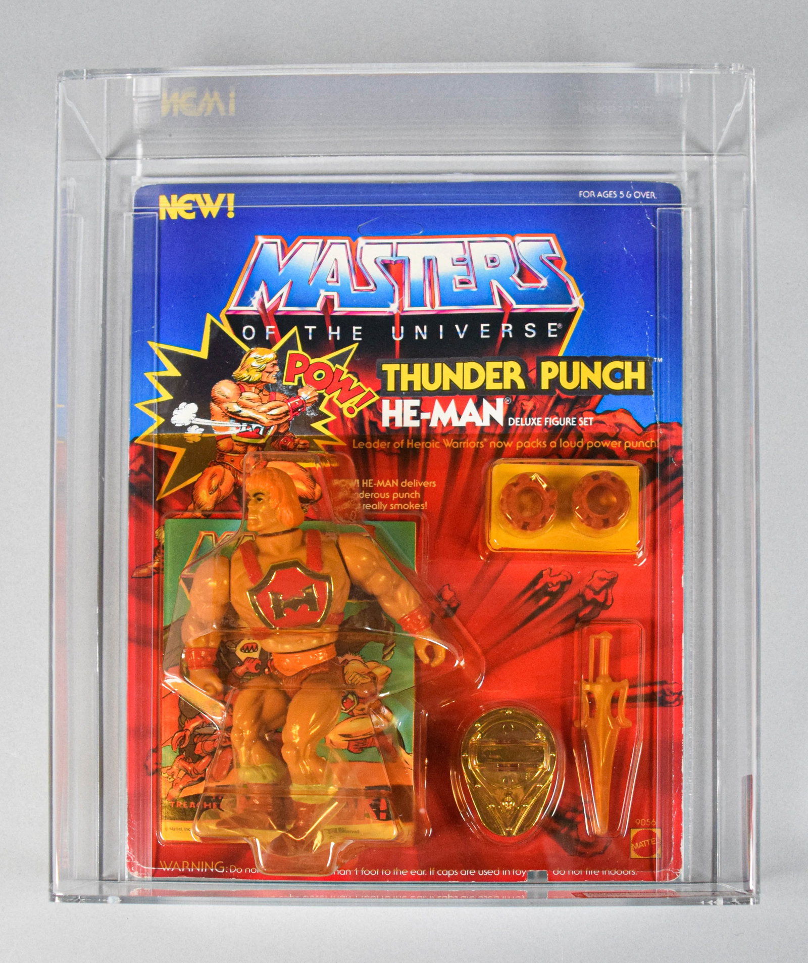 Mattel 1985 MOTU Thunder Punch He-Man AFA 75+: 1985 Mattel Masters of the Universe (MOTU) Series 4 Thunder Punch He-Man deluxe figure set, factory-sealed on the original card. Stored in clear acrylic display case with AFA (Action Figure Authority)