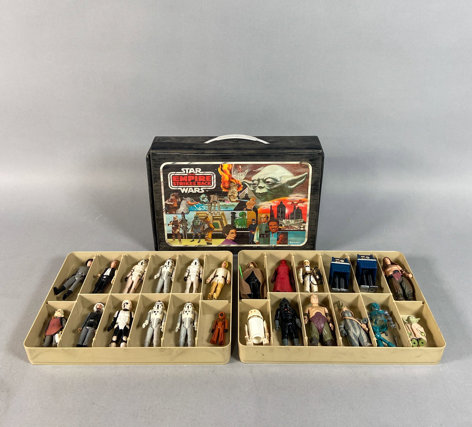 24 Vintage Kenner Star Wars Action Figures Incl Carrying Case c. 1980-1985: Collection of 24 vintage Kenner Star Wars action figures with a The Empire Strikes Back vinyl carrying case. The interior includes two plastic multi-compartment divider trays designed for figure stora