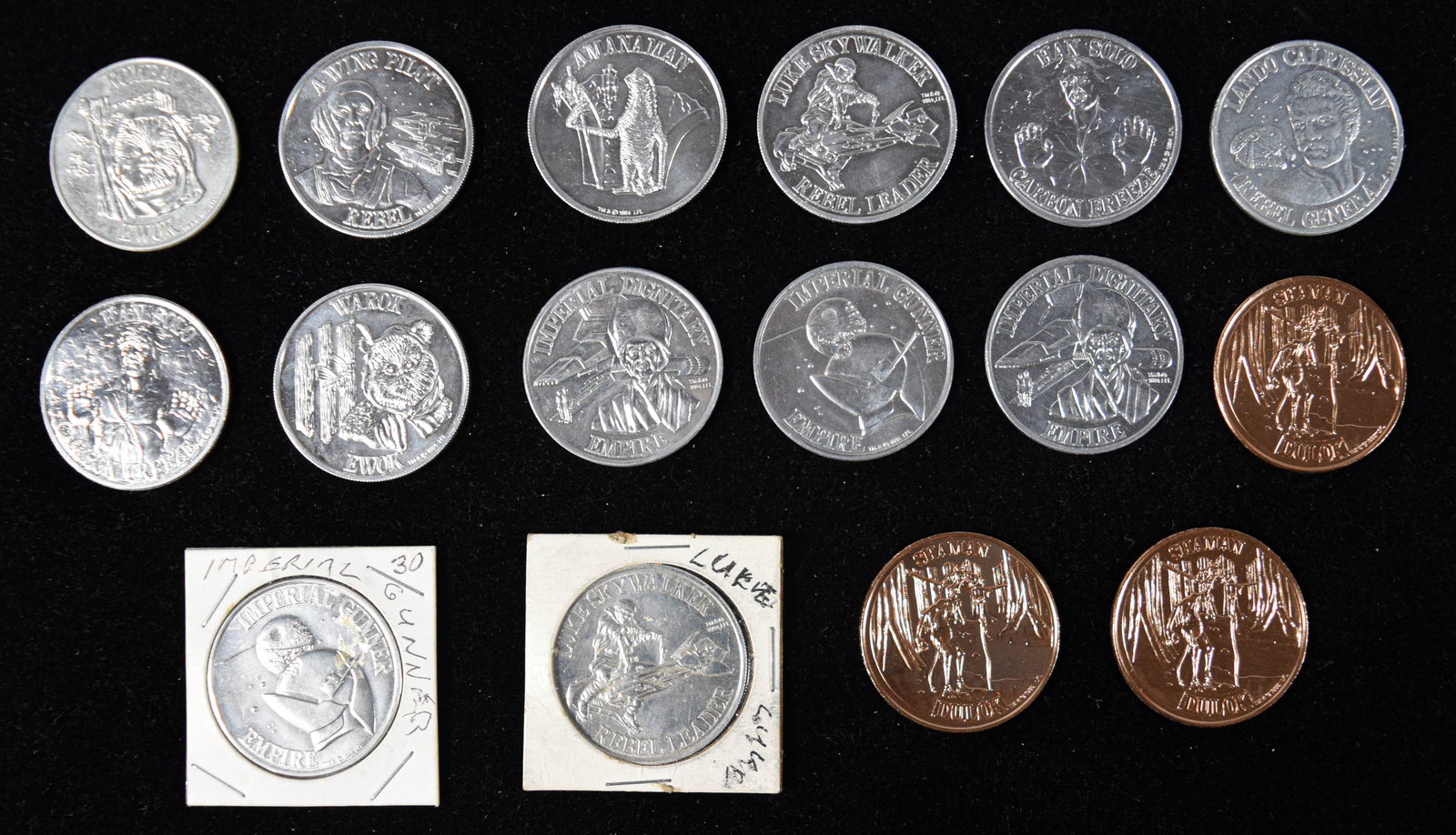 16 Star Wars and Ewoks Promotional Coins: Collection of 16 metal promotional coins produced for the Star Wars Power of the Force and Ewoks animated series lines. The group includes silver-toned coins marked 1984 LFL and 1985 LFL featuring cha