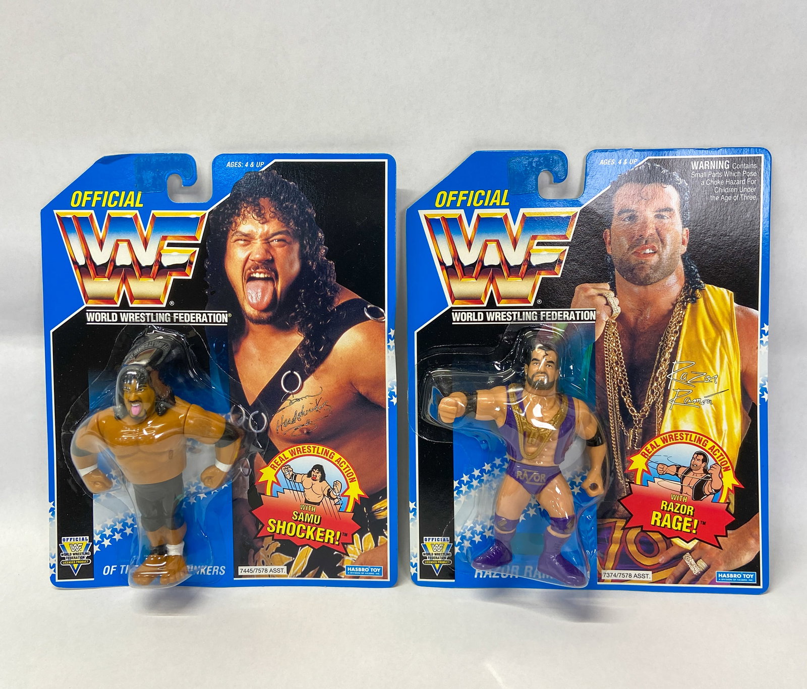 2 Factory-Sealed Hasbro WWF Action Figures (Samu and Razor Ramon) 1993-1994: Group of two official World Wrestling Federation (WWF) action figures manufactured by Hasbro in 1993 and 1994. The first figure is Samu from "The Headshrinkers" tag team featuring the "Samu Shocker!"