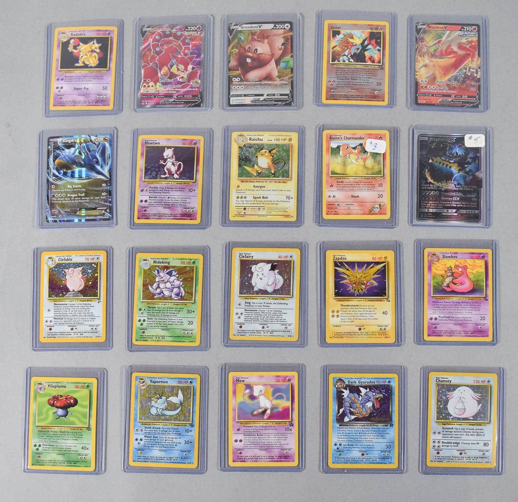 20 Nintendo and Wizards of the Coast Pokemon Trading Cards c. 1999-2021: Collection of 20 Pokemon trading cards featuring a selection of vintage cards produced by Wizards of the Coast, including several sought-after holographic editions from the original Base Set, Jungle,