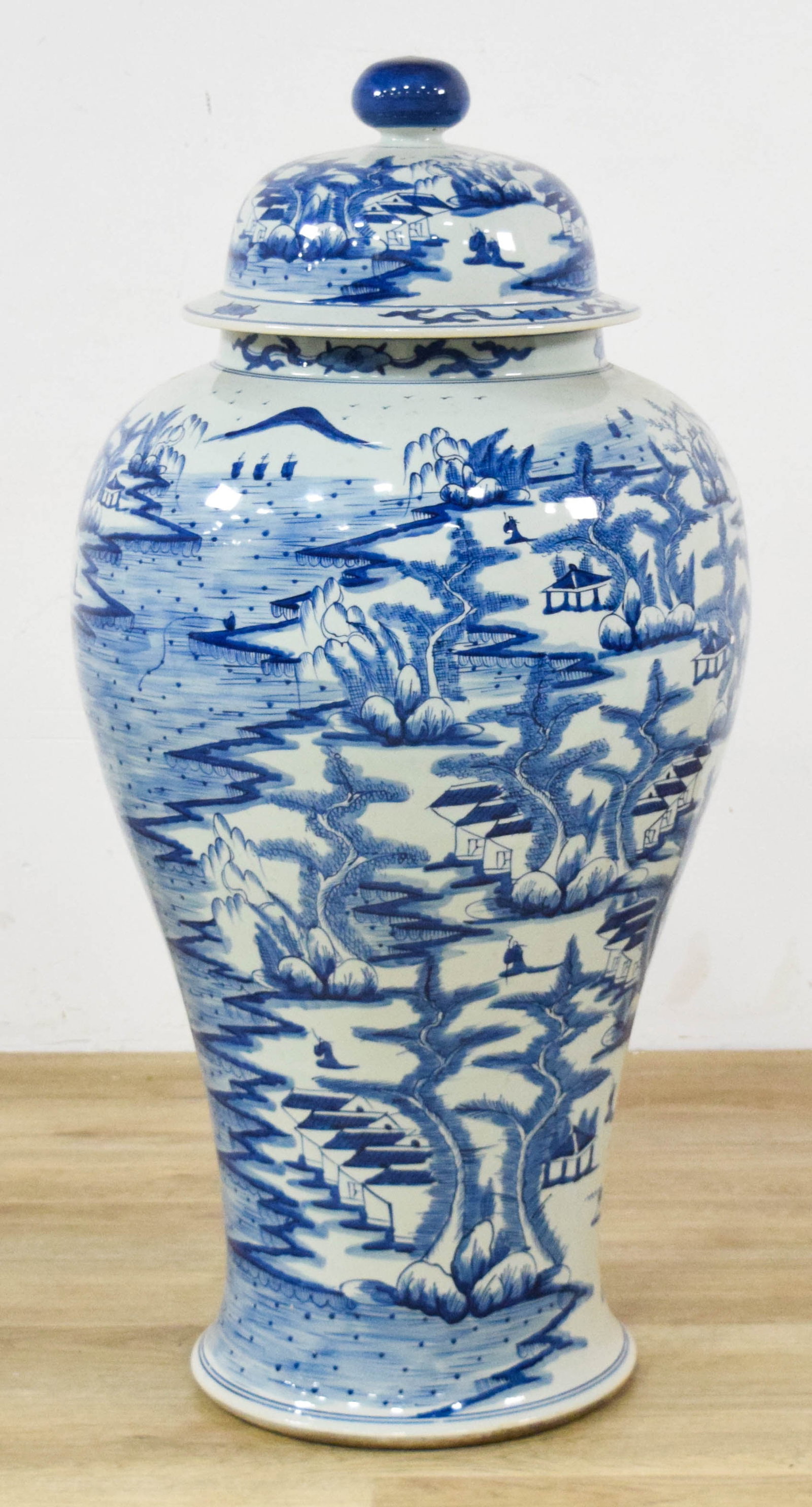 Oversized Chinese Blue and White Porcelain Ginger Jar: Floor standing Chinese blue and white porcelain ginger jar. Hand-painted landscape scenes with traditional Chinese decorative elements throughout the body and lid. 39" H x 13" base diameter.