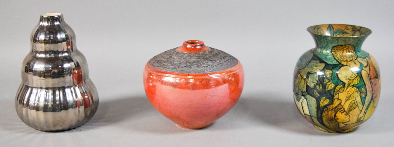 3 Contemporary Pottery Vases Incl Dudley Vaccianna: Group of three contemporary pottery vases. Includes a ceramic vase with a silver metallic luster glaze, a spherical Raku bud vase with an orange crackle finish, and a third vase with hand-painted moti