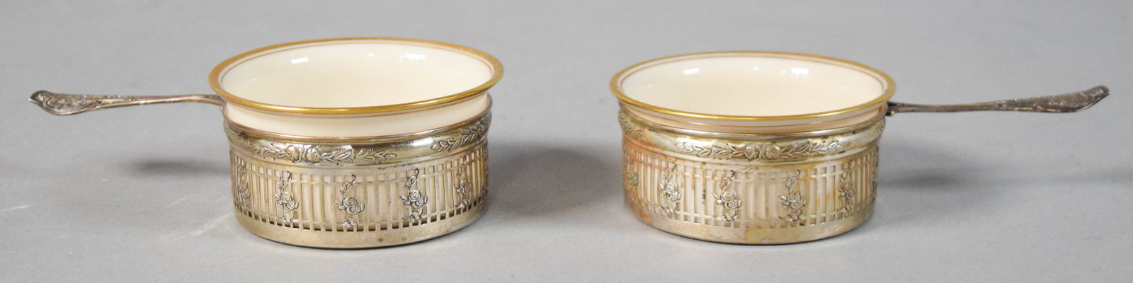 Pair of Lenox Porcelain Ramekins in Art Nouveau Sterling Silver Holders: Pair of Lenox porcelain ramekins in Art Nouveau sterling silver holders. Underside of each porcelain liner with green Lenox mark. Underside of each silver holder stamped Sterling. Sterling holders 68 