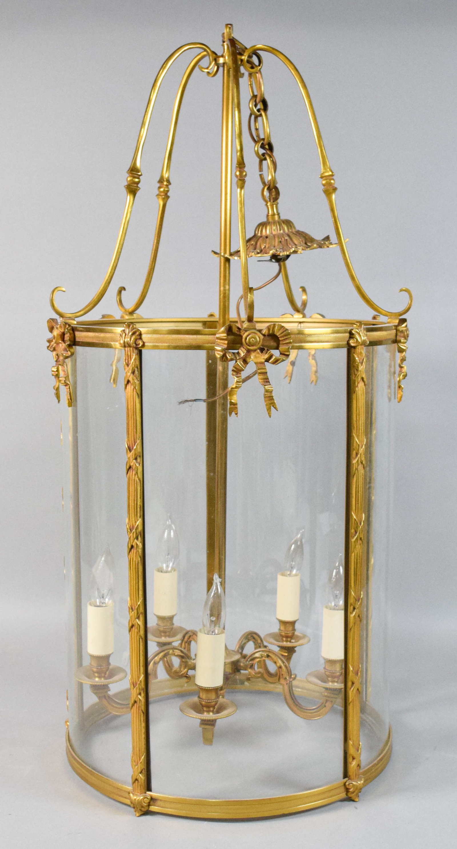 Louis XVI Style Gilt-Metal and Glass Five-Light Lantern Chandelier: Large Louis XVI style gilt metal and glass five-light lantern chandelier. The frame is ornamented with cast-metal ribbon-and-bow mounts at the top of each vertical stile and a horizontal reeded band w