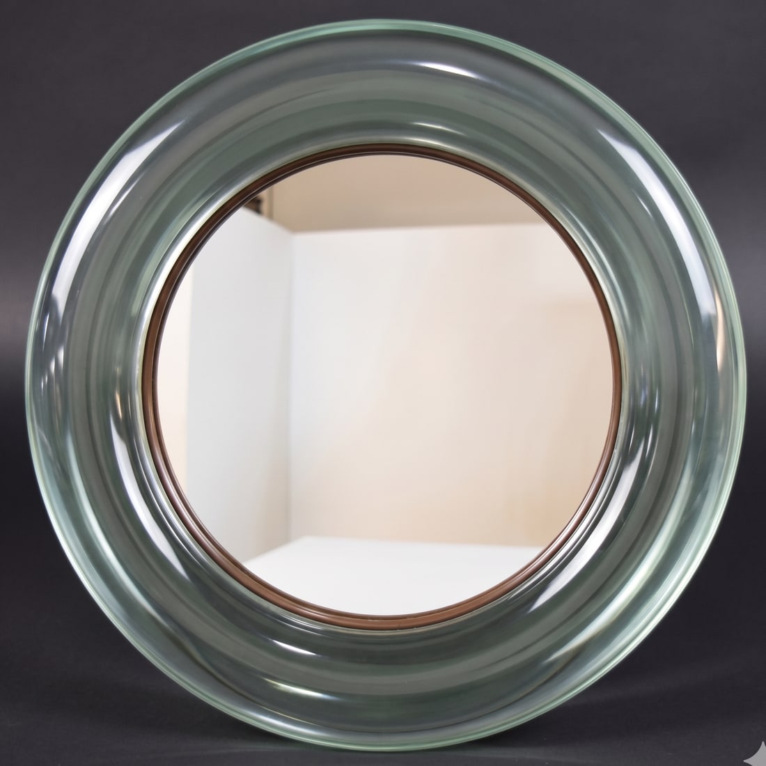 MCM Style Translucent Green Glass Vanity Mirror: Mid-Century Modern style glass tabletop vanity mirror. Thick, translucent pale green glass. Easel stand for tabletop display. 15" diameter.
