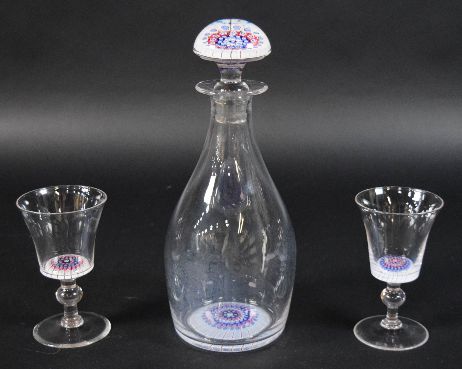 Three-Piece Millefiori Paperweight Crystal Liqueur Set: Three-piece millefiori paperweight inset lead crystal liqueur set with a decanter and matching stemware. Each piece, including the dome of the stopper, contains a complex millefiori weight at the base