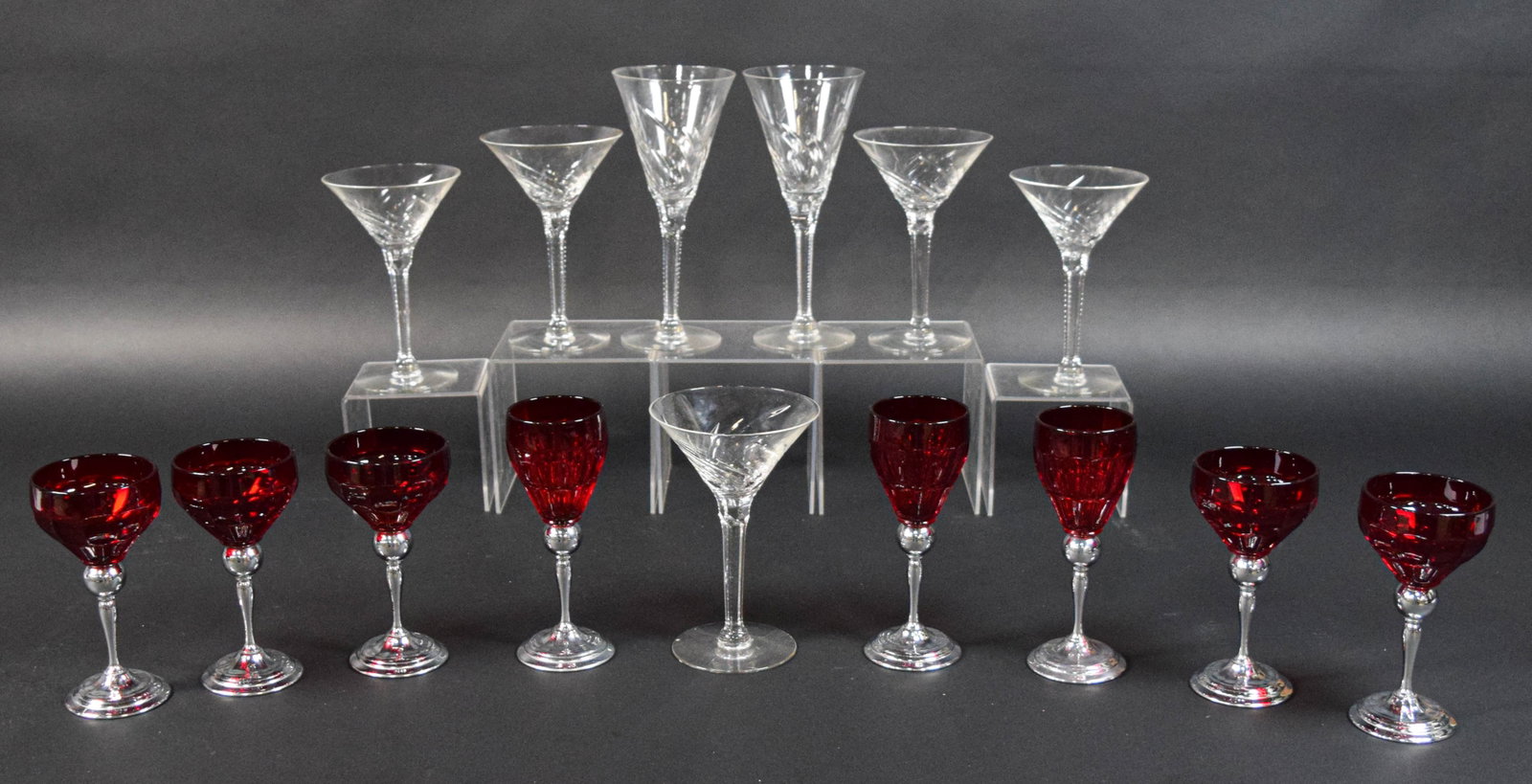15 Pieces of Cut Crystal and Farberware Ruby Glass Stemware: Collection of 15 pieces of stemware including seven pieces of clear cut crystal flutes and martini glasses and eight pieces of ruby red glass and chrome-plated goblets and wines, marked Farberware Chr
