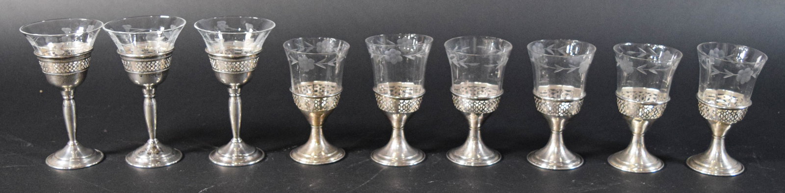 9 Pieces S.A. Schwarz Co. Sterling Silver and Etched Glass Stemware: 9 pieces of S.A. Schwarz Co. stemware with sterling holders and removable glass inserts. Silver holders with pierced gallery and flared circular bases. Glass inserts with etched floral and vine patter