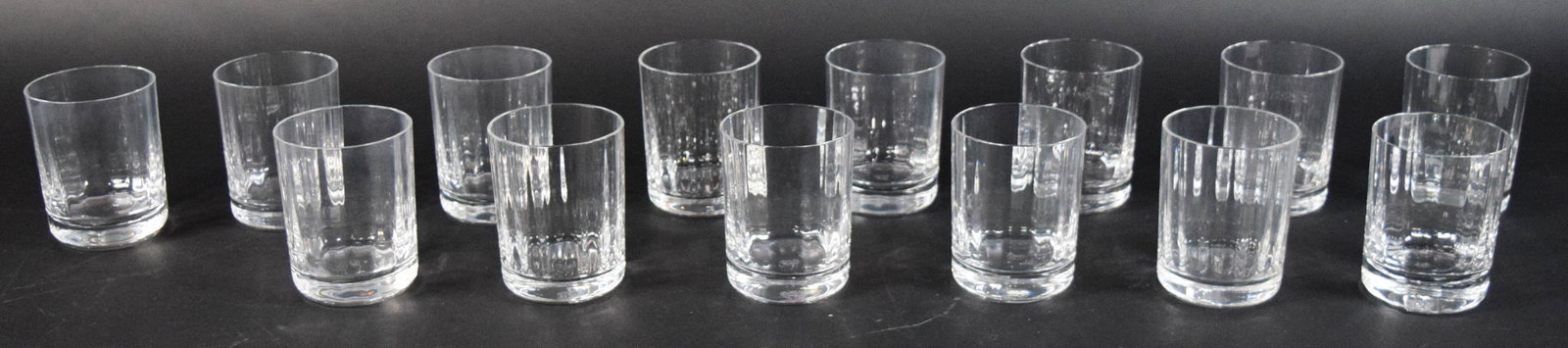 Set of 14 Baccarat Crystal Harmonie Old Fashioned Glasses: Set of 14 Baccarat crystal old fashioned glasses in the Harmonie pattern. Each tumbler with a cylindrical form and weighted base. Each glass signed on the underside. 4" H x 3 1/4" diameter.